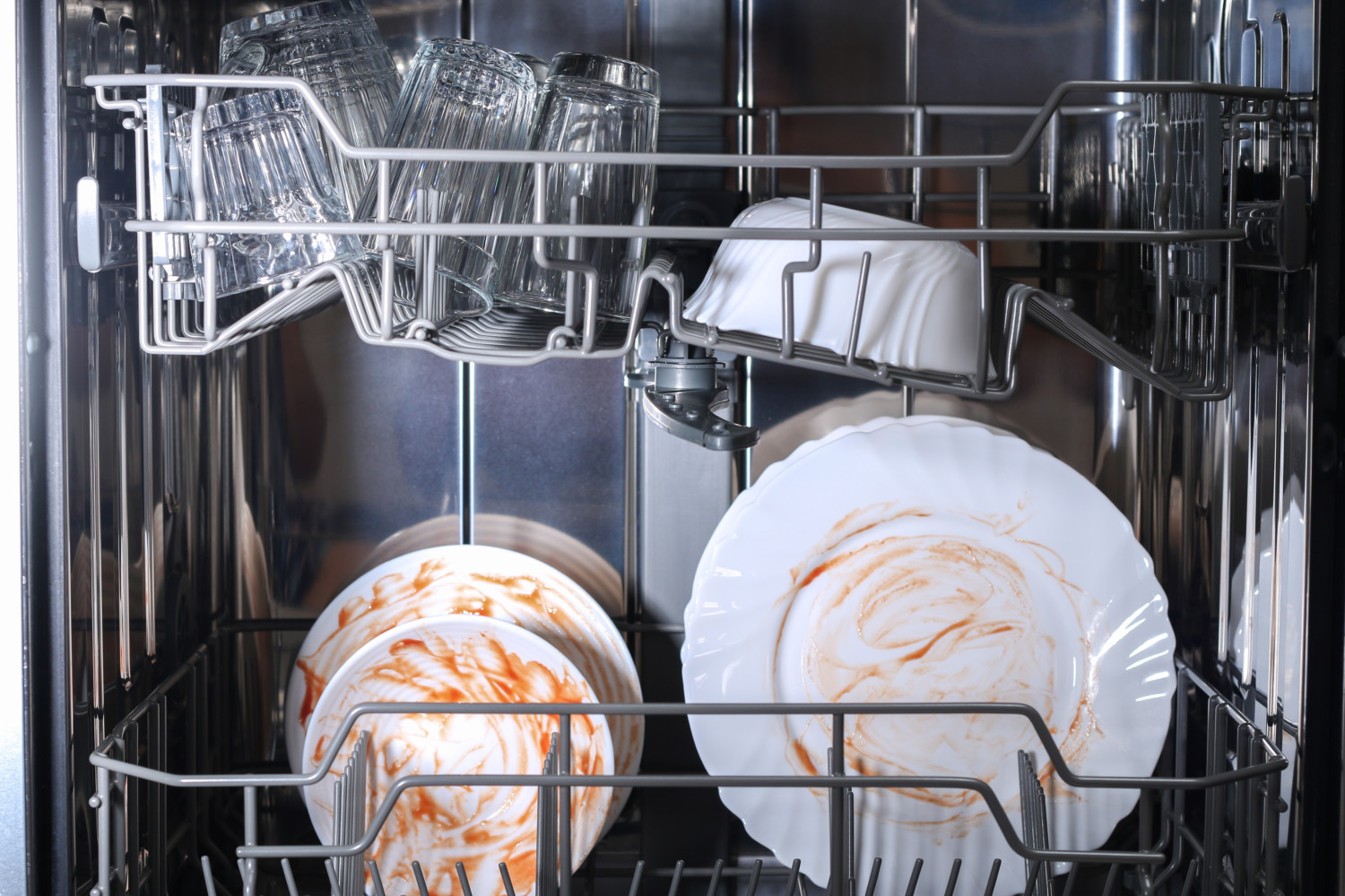 Dirty dishes sitting inside dishwasher