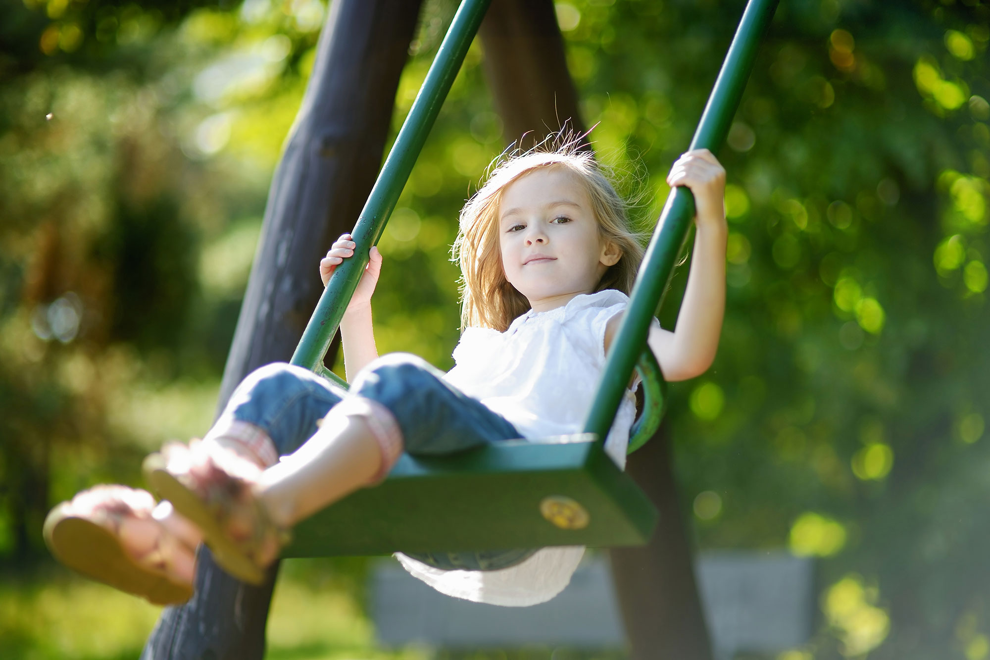 Children Playing On A Swing