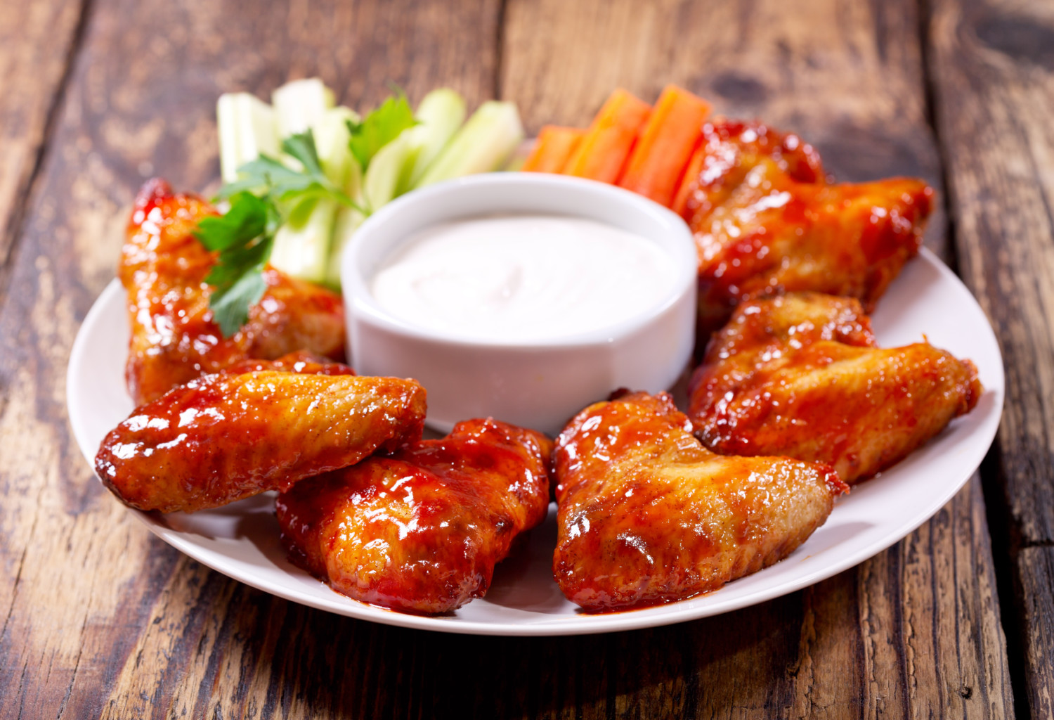 Buffalo wings on plate with dip and celery