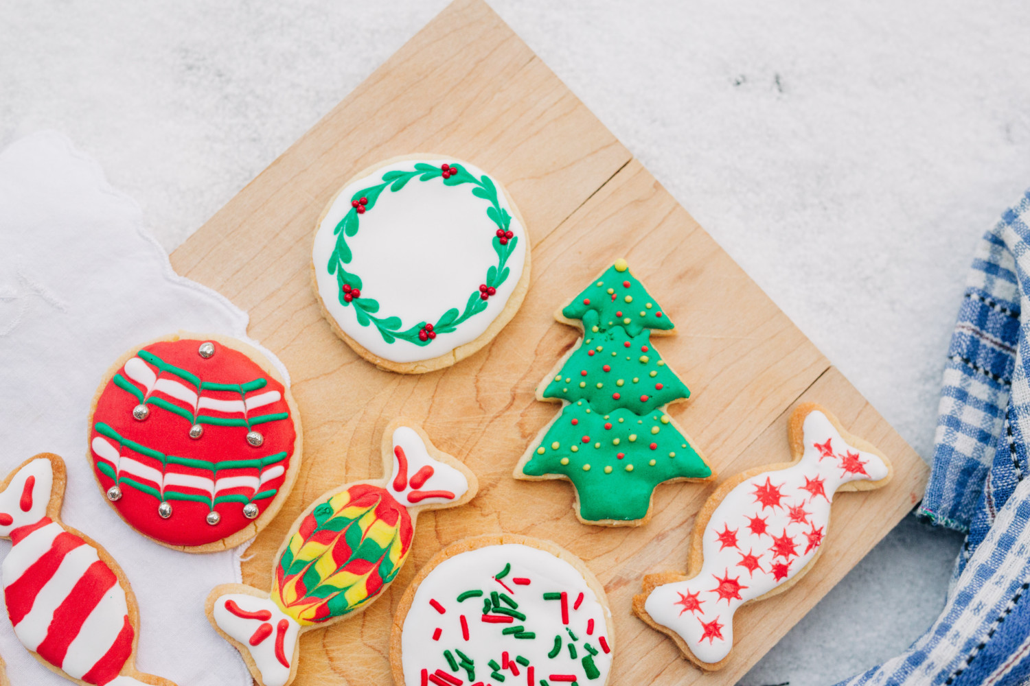 Frosted sugar cookies on wooden board, holiday cookie recipe