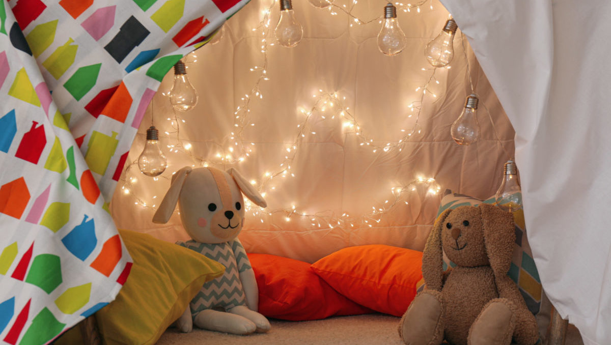 String holiday lights used in play space pillow fort