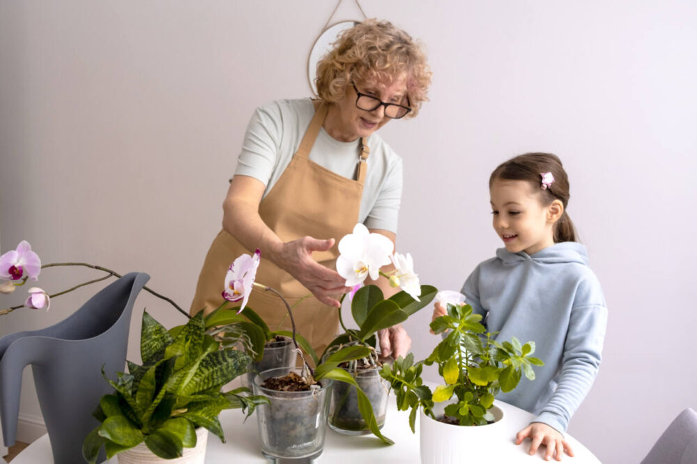 woman and child tend to orchid plants