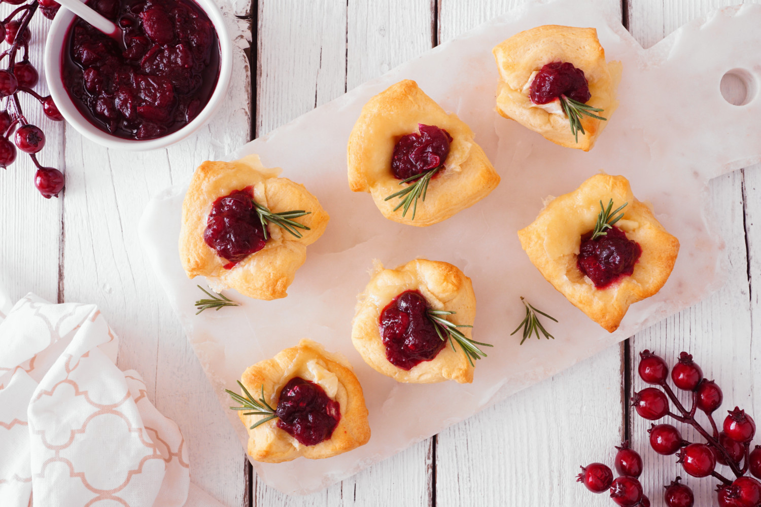 Holiday puff pastry appetizers with cranberries and baked brie.