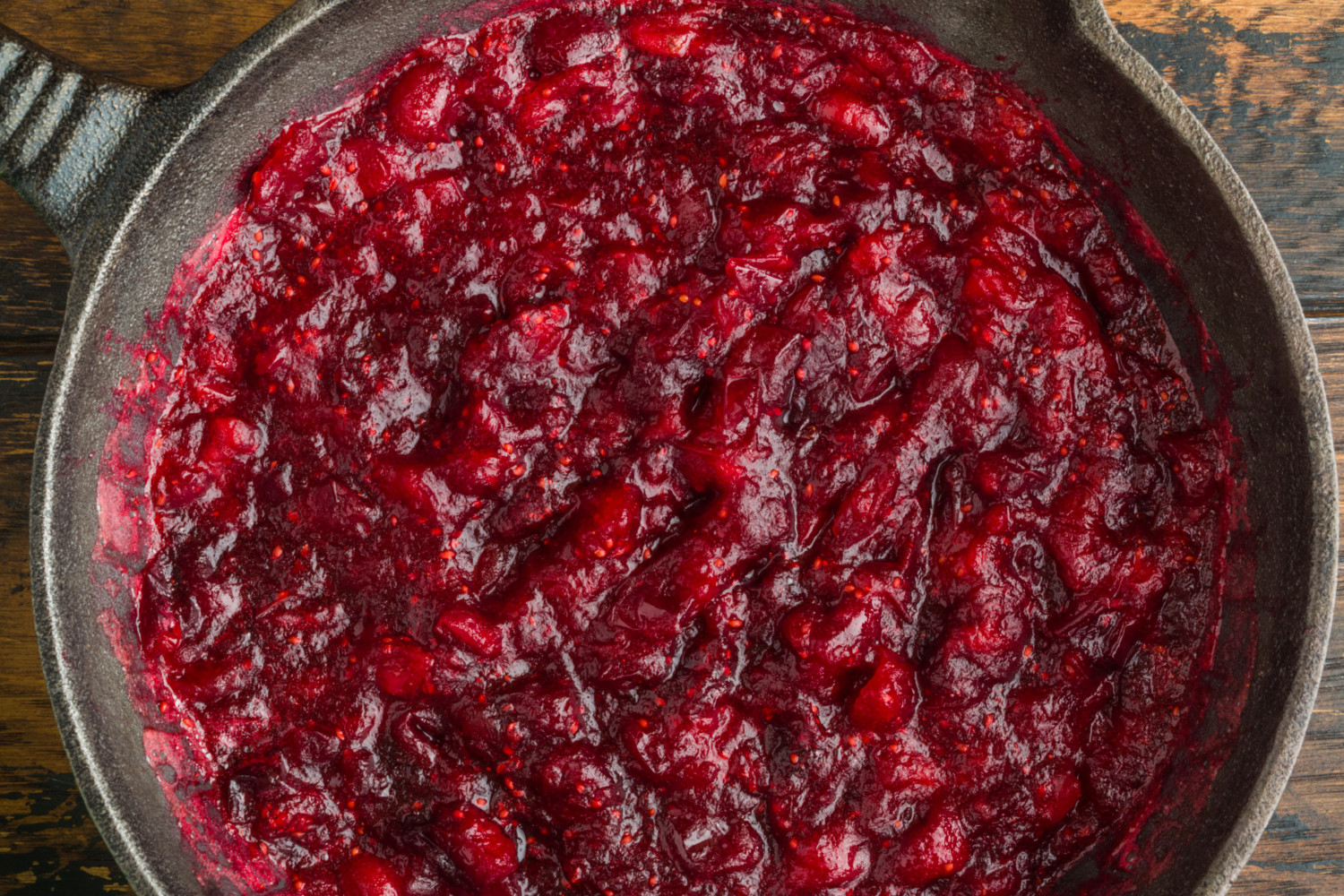 Traditional cranberry sauce in black cast-iron skillet