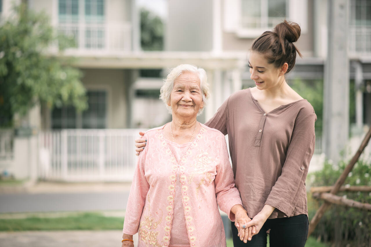 senior woman smiles with young woman