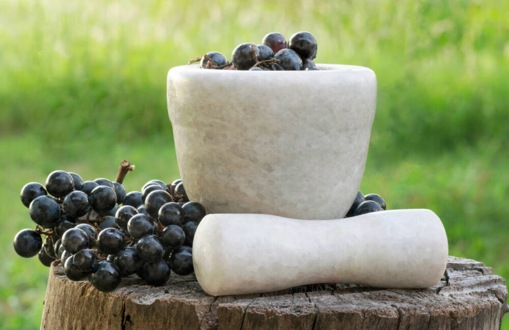 Mortar and pestle filled with grapes