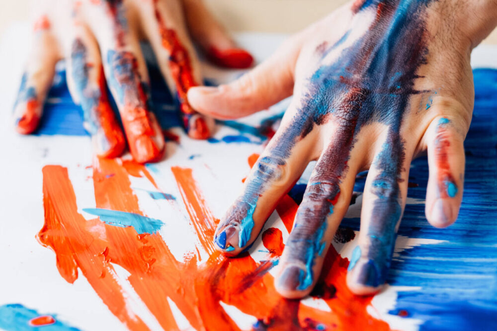 hands covered in paint