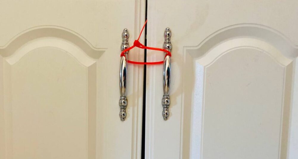 zip tie secures cabinet handles