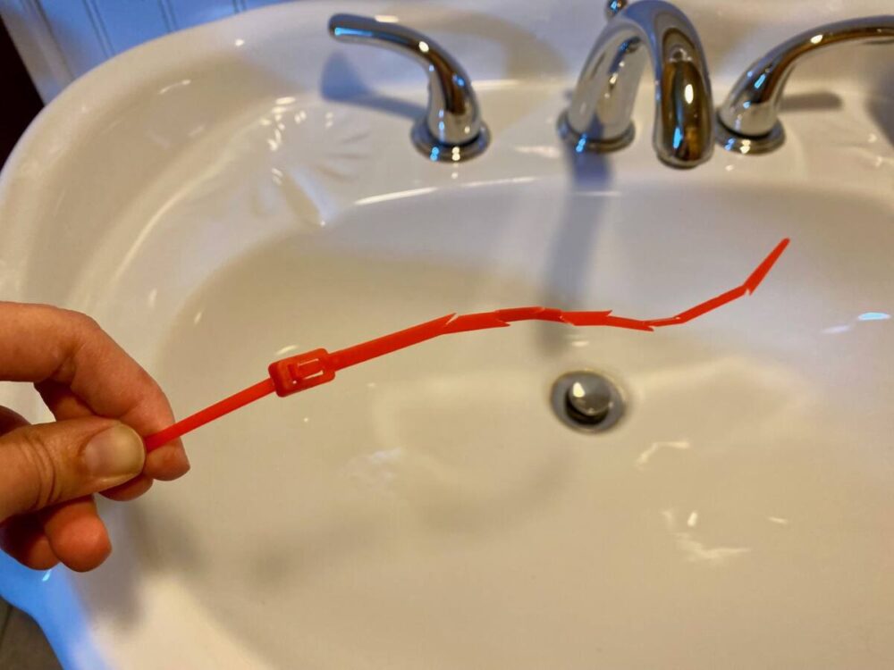 zip tie altered to snake drain