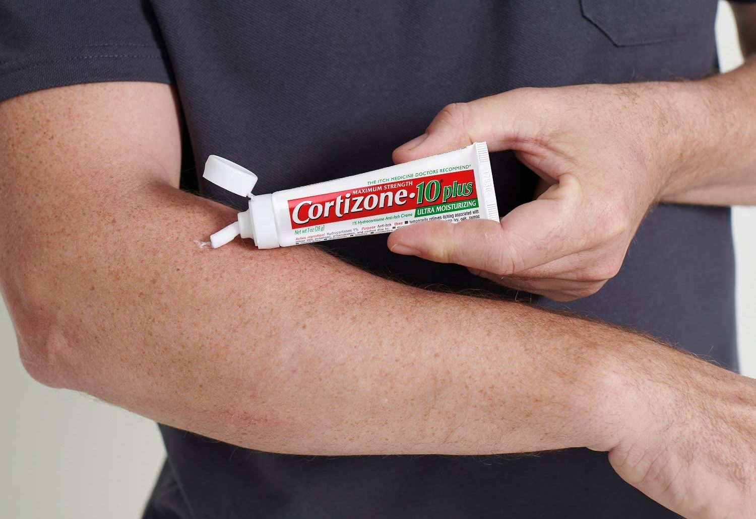 Man putting Cortizone 10 anti-itch cream on arm