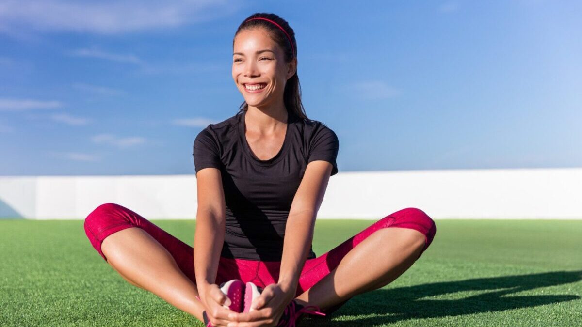 Happy woman stretches for exercise