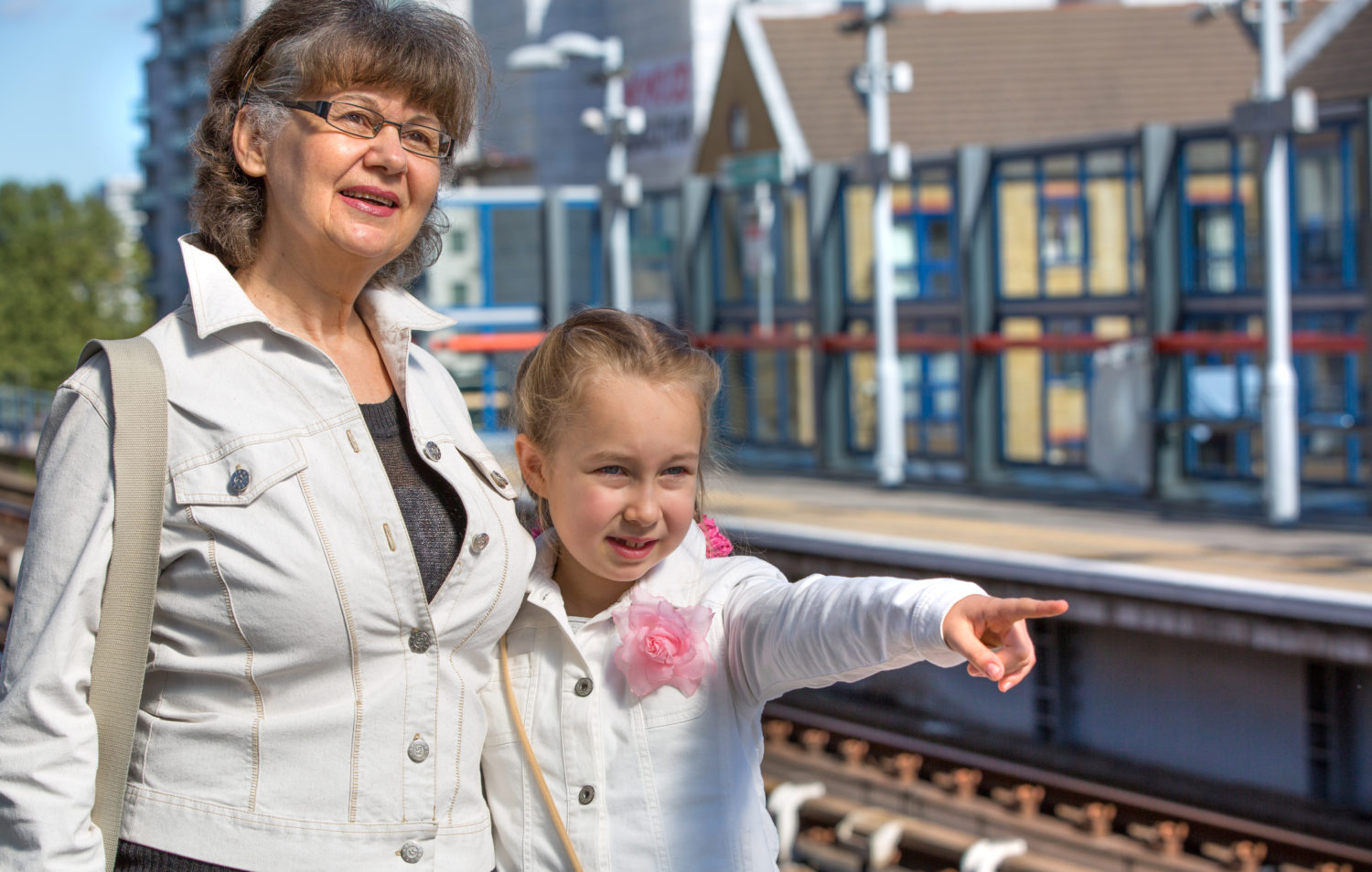 Little girl and grandmother waiting train on the platform, London