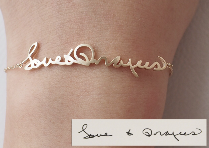 gold bracelet that reads "love and prayers" in handwriting