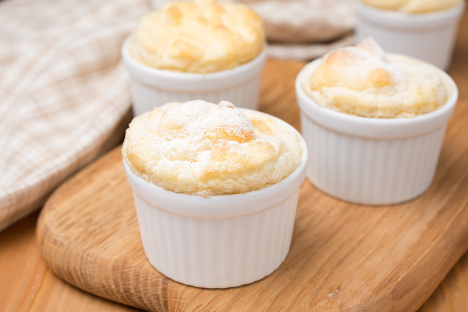 peach souffle in the portioned form on a wooden board, close-up