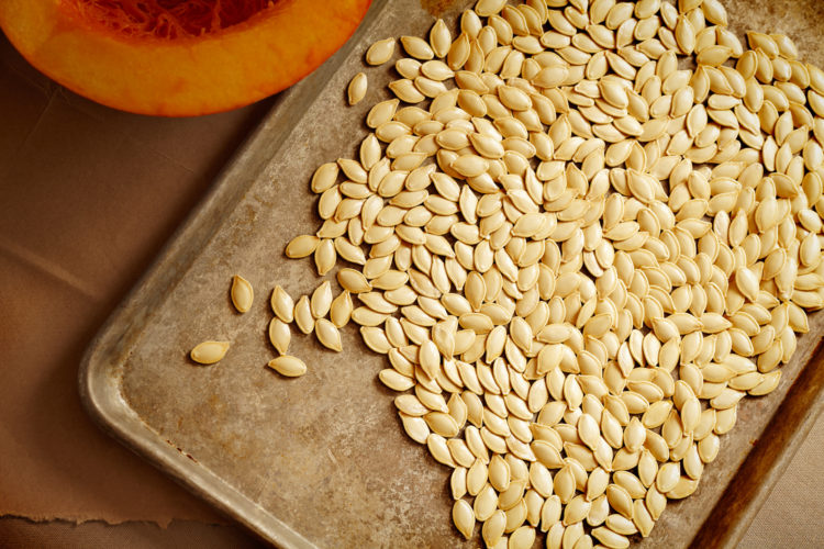 Preparing Pumpkin Seeds for the oven.