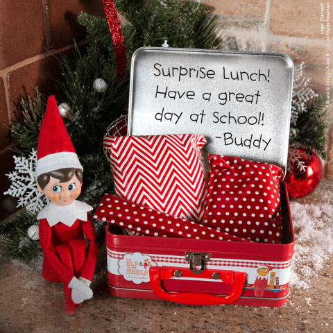 Elf on the Shelf poses next to lunch box
