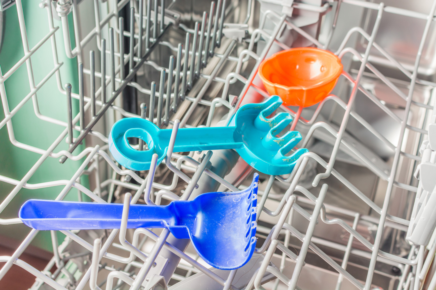 Children's toys in top rack of dishwasher