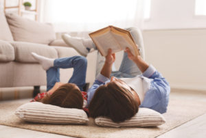 Parent and little girl read book together