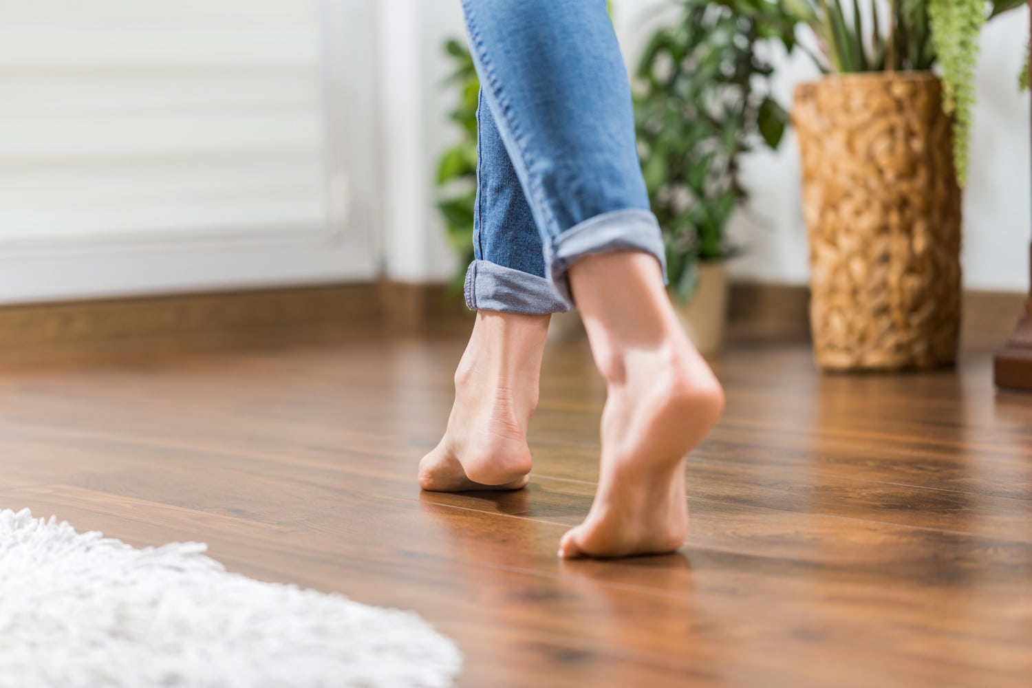 Woman walking barefoot on hard wood floor