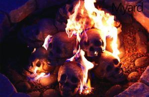 Human skull logs burning for Halloween