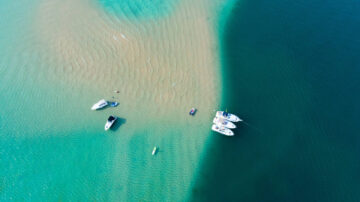 Boats anchor at the sand bar in Torch Lake