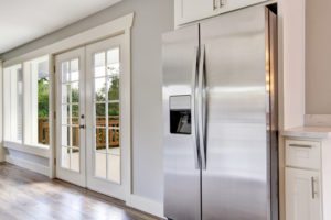 Bright kitchen with stainless steel refrigerator