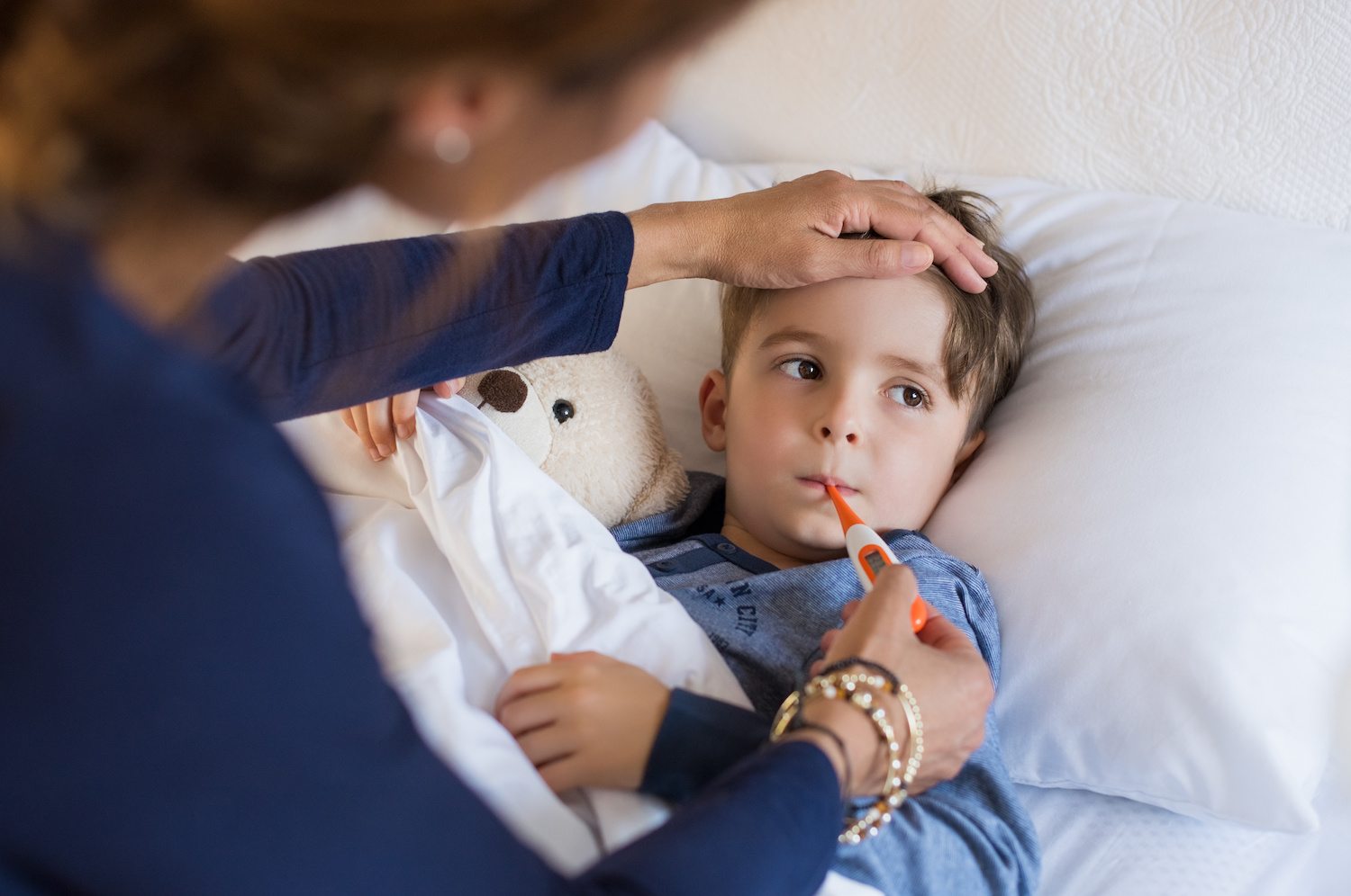 Boy with fever having temperature taken