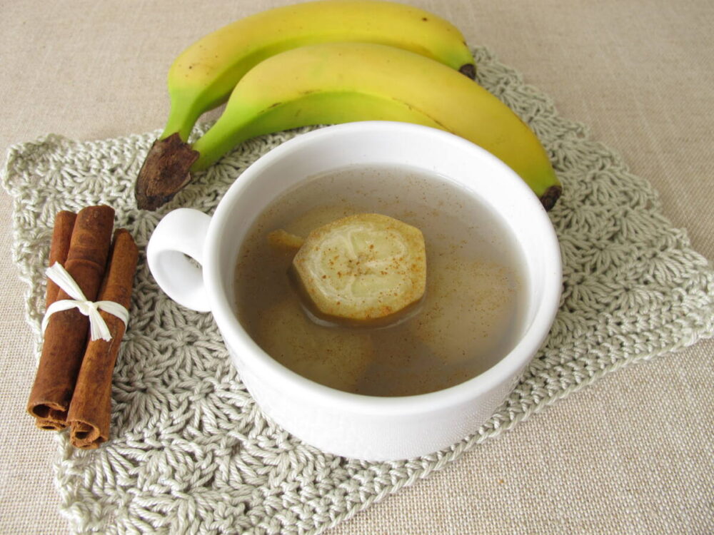 Banana with peel in tea cup