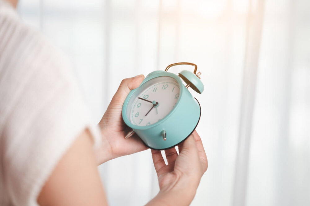 Woman sets time on clock