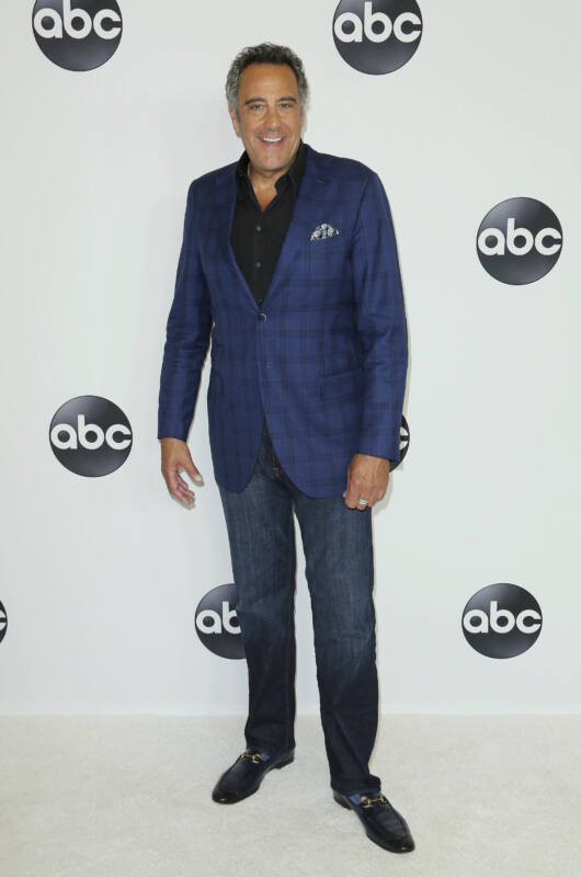 Actor Brad Garrett stands smiling at red carpet event