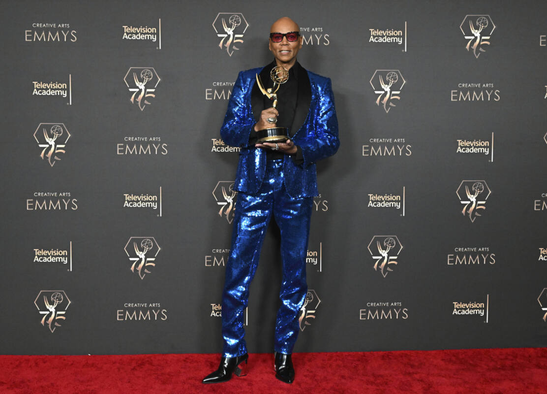 RuPaul poses with Emmy for outstanding host