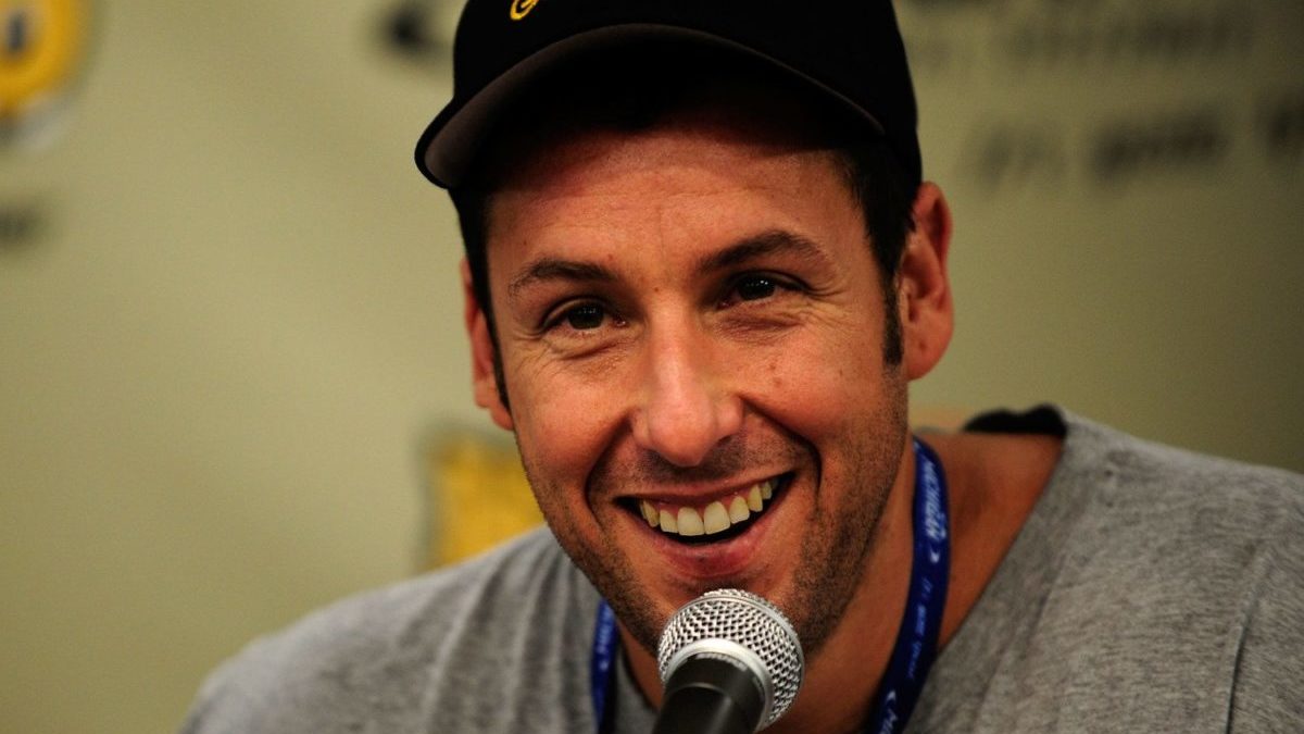 Adam Sandler talks to the media in 2010 at a NASCAR press conference.