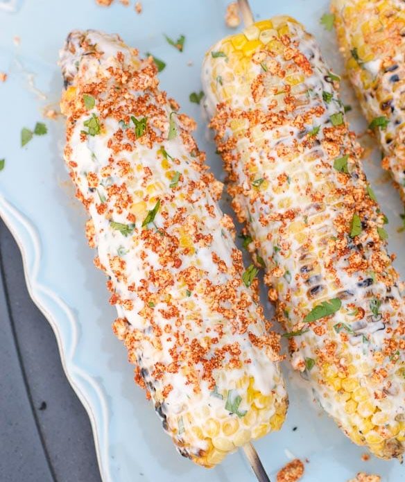 Mexican street corn on white plate