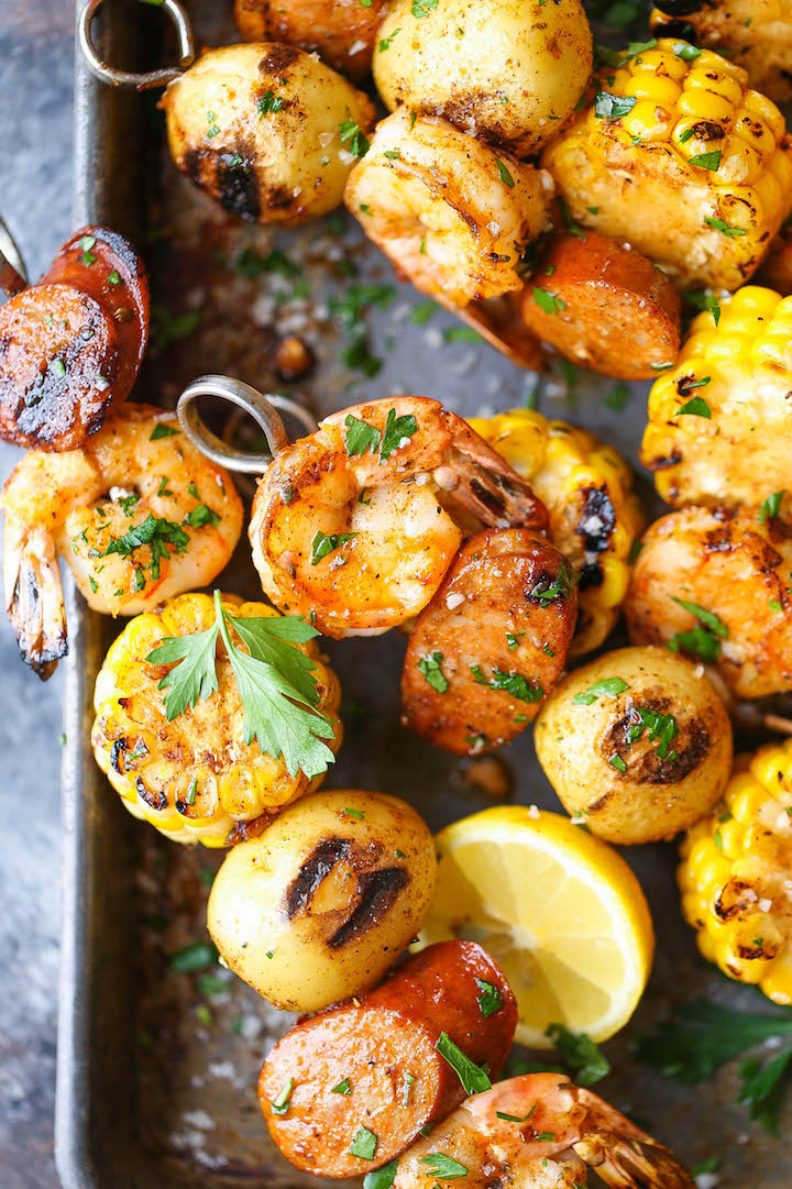 Shrimp boil kabobs on baking tray with corn