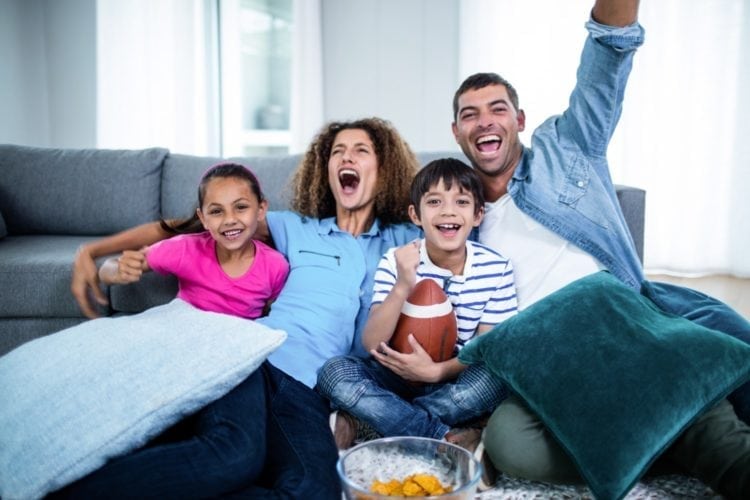 Family watches football together on TV
