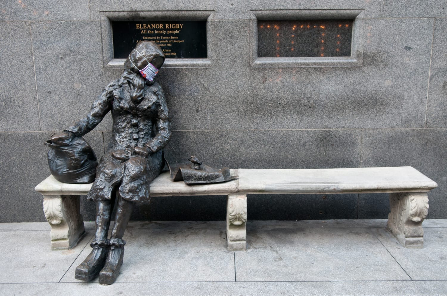 cross-stitched mask on Eleanor Rigby statue: provoking people to think about community, loneliness and society