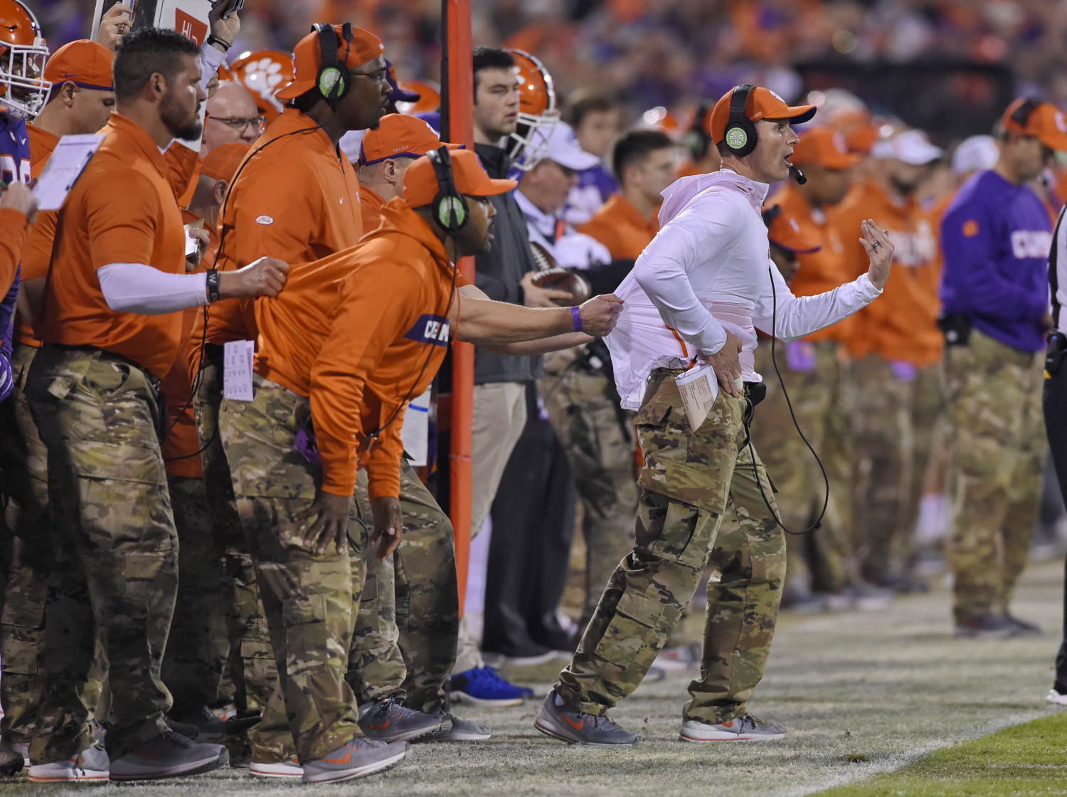 Clemson defensive coordinator Brent Venables is pulled back to the sideline by a get-back coach.