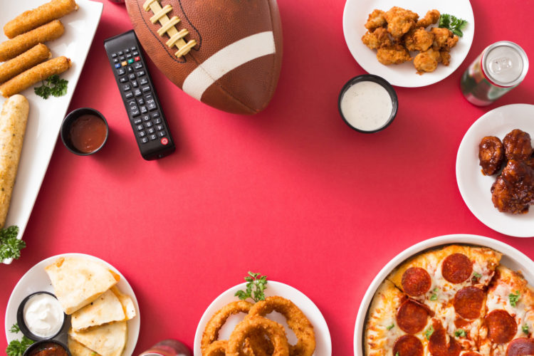 A football with party food and a remote control
