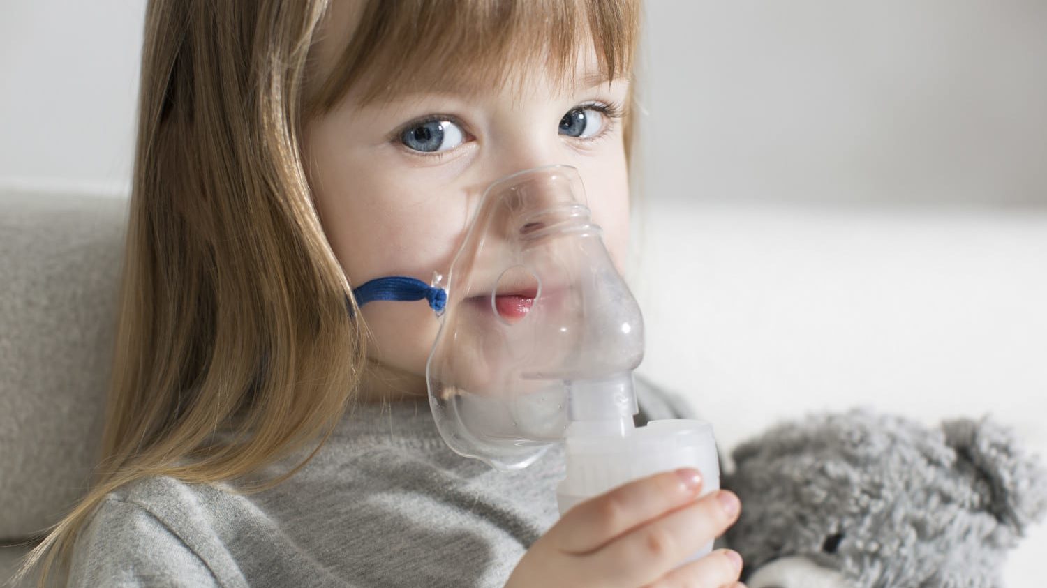 Little girl using nebulizer for asthma