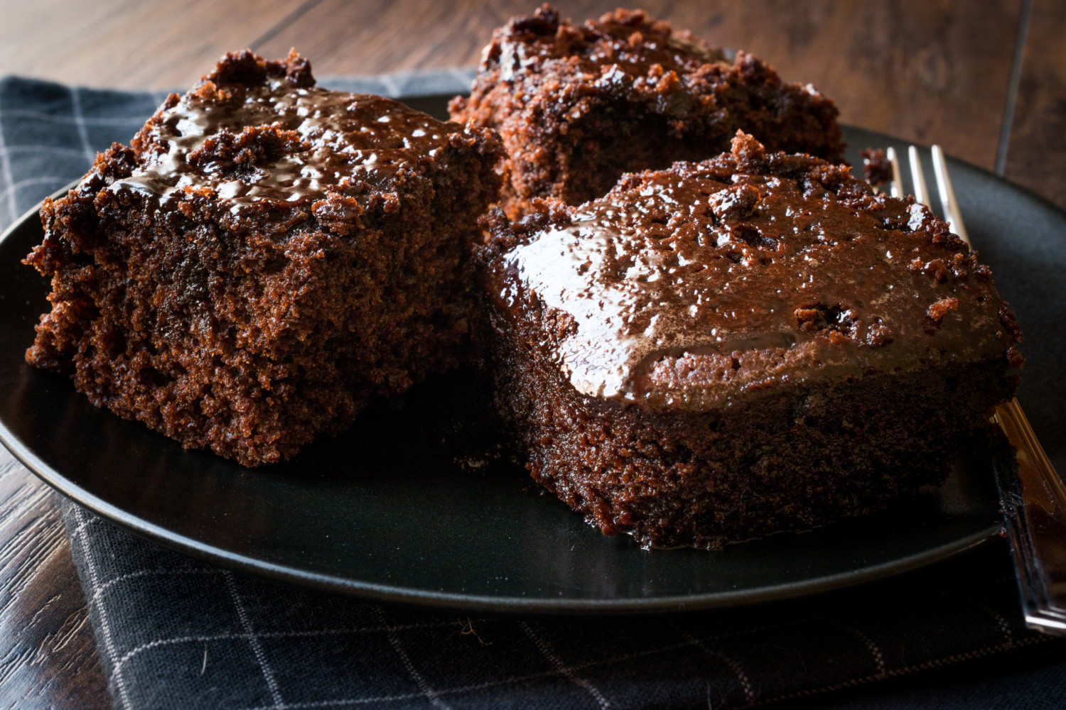 Moist Chocolate Sponge Cake Brownie Pieces in Black Plate. Organic Desert.