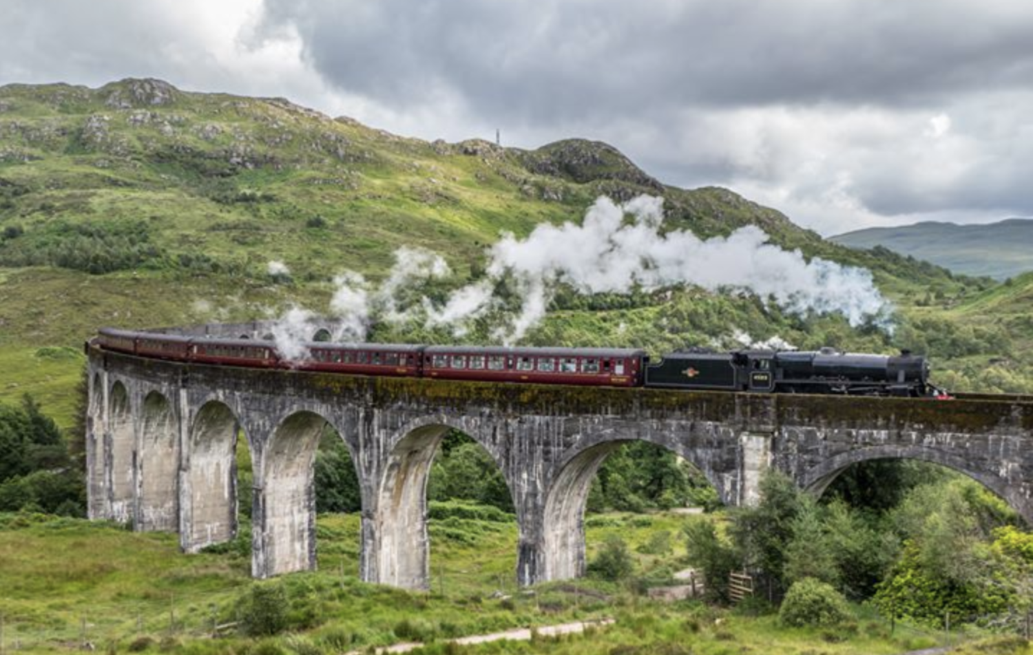 The Jacobite train, also known as the Hogwarts Express, crosses a bridge in Scotland