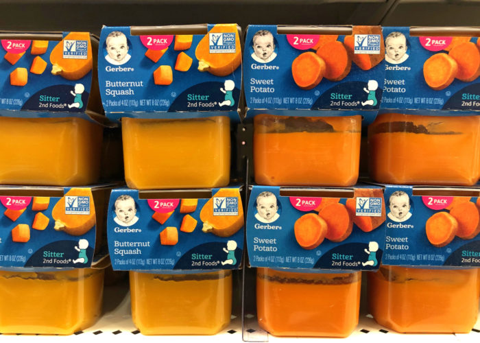 Plastic containers of Gerber's brand 2nd stage baby foods on a grocery store shelf