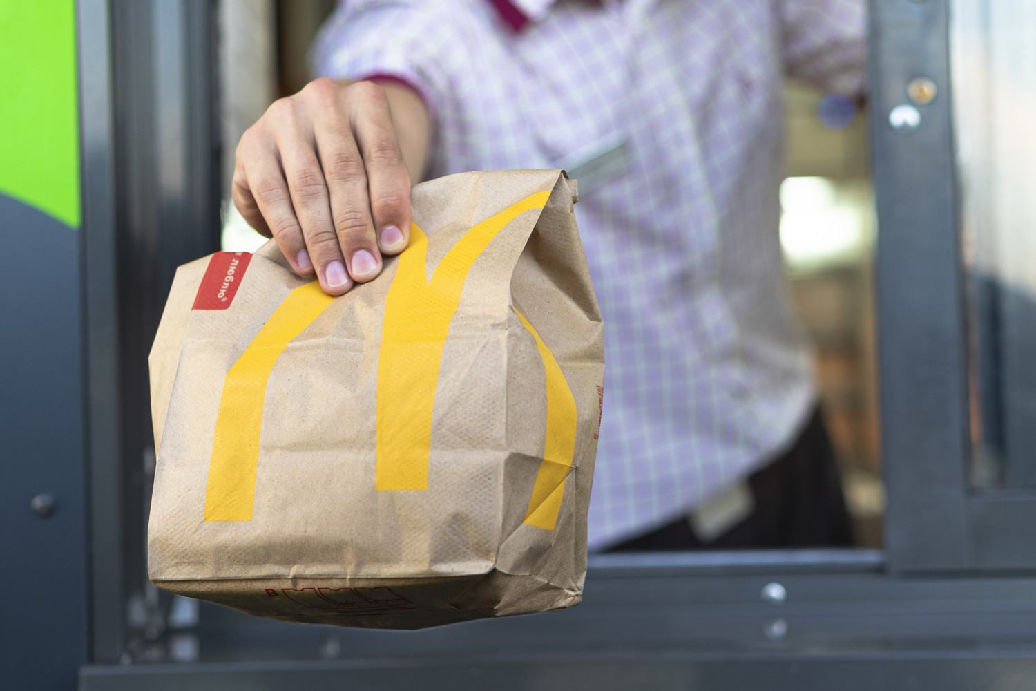 McDonald's drive-thru worker with bag