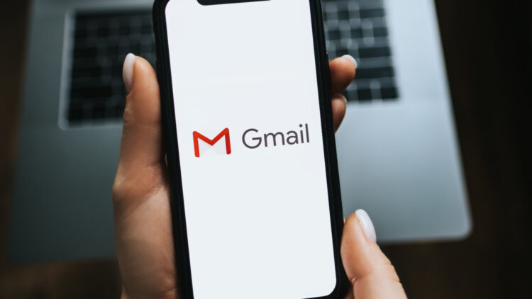Hand holds iPhone with Gmail