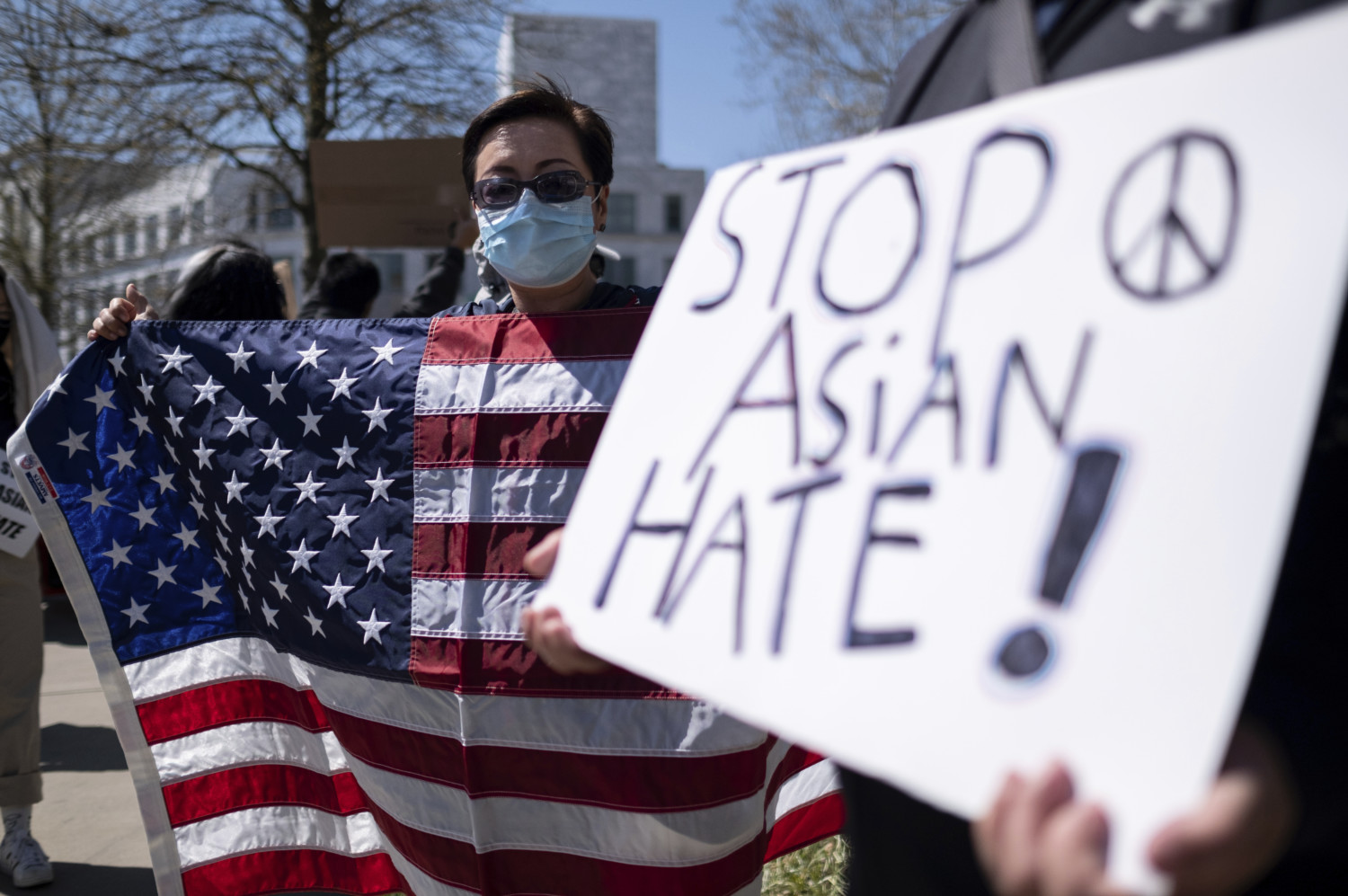 Protestor holds "stop Asian hate" sign