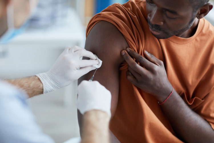 Man getting COVID-19 vaccination in arm