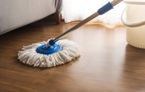 Cleaning a wood floor with a mop