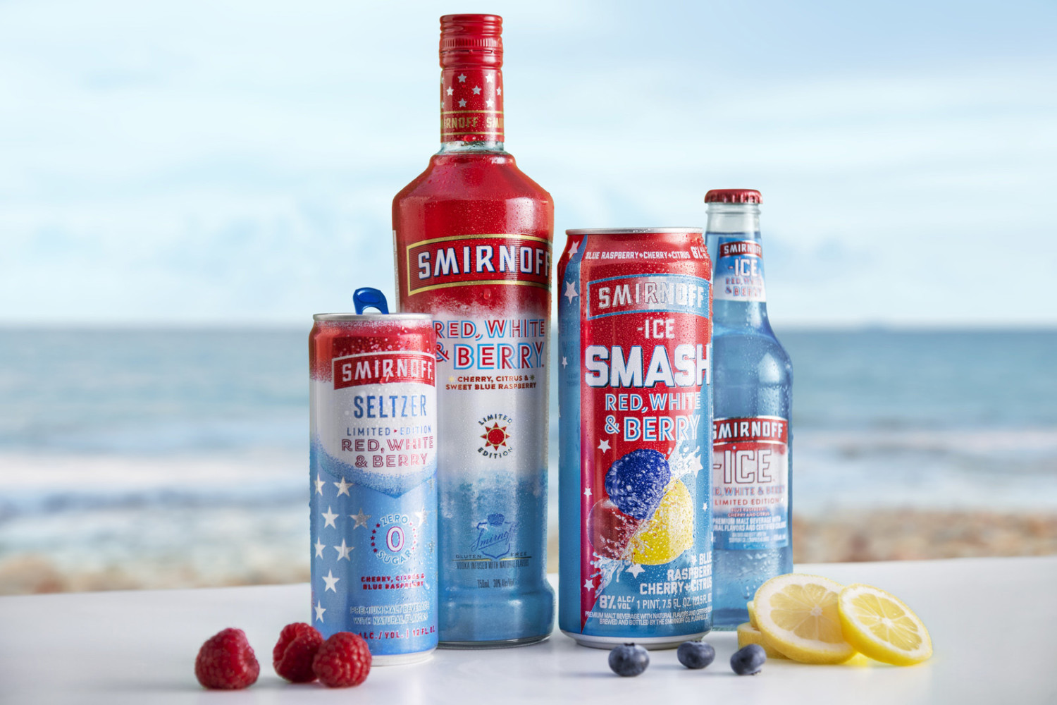 A beach scene with the four kinds of Smirnoff Red, White & Berry flavored beverages: canned seltzer, bottle of vodka, smash flavor can, and bottled ice flavor 