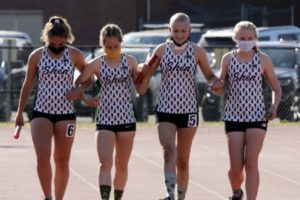 high school runner helped to finish line by teammates