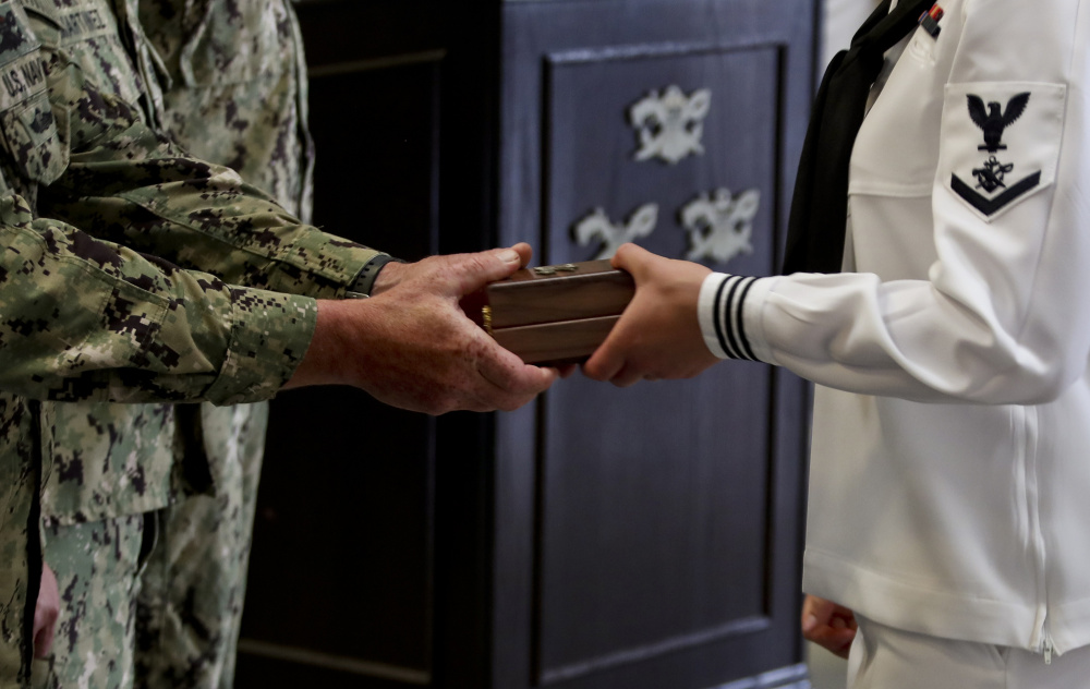 Graduate of Crewman Qualification Training Class 115 receives a compass at Naval Special Warfare Center